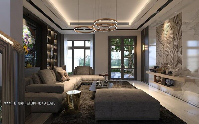 Trang trí nội thất phòng khách ấn tượng với cách kết hợp hài hòa giữa sắc trầm và sáng cùng hệ cửa kính lớn giúp không gian trở nên thông thoáng, sang trọng. Thiết kế phòng khách độc đáo